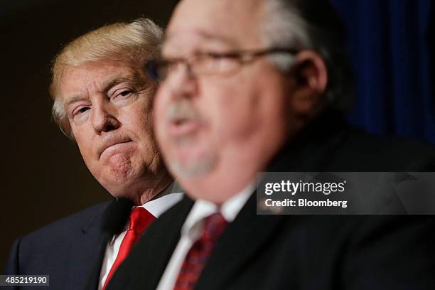 Donald Trump, president and chief executive of Trump Organization Inc. And 2016 Republican presidential candidate, left, looks on as Sam Clovis,...