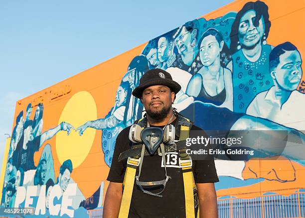 Brandan "BMike" Odums poses in front of The Wall of Peace mural at The Grand Theater on August 25, 2015 in New Orleans, Louisiana. The timing of the...