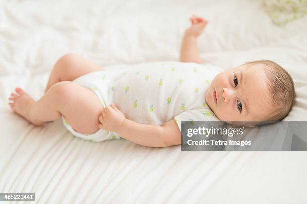 baby boy (2-5 months) lying on bed - mexican and white baby stock pictures, royalty-free photos & images