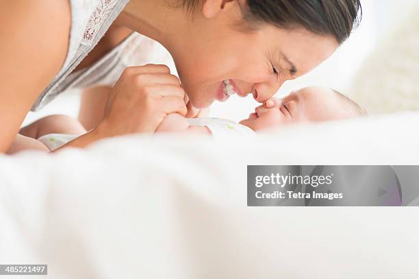 mother playing with baby boy (2-5 months) - rubbing noses stock pictures, royalty-free photos & images