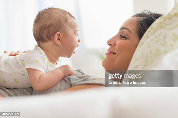 mother playing with baby boy (2-5 months) - mexican and white baby stock pictures, royalty-free photos & images