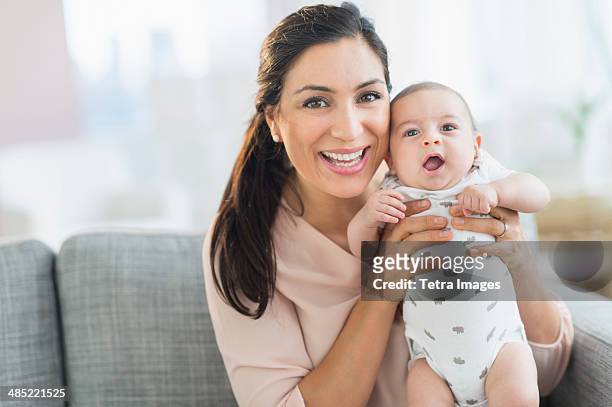 mother holding baby boy (2-5 months) - mexican and white baby stock pictures, royalty-free photos & images