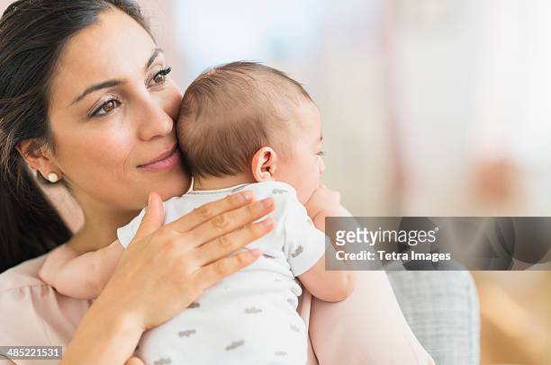 mother embracing baby boy (2-5 months) - mexican and white baby stock pictures, royalty-free photos & images