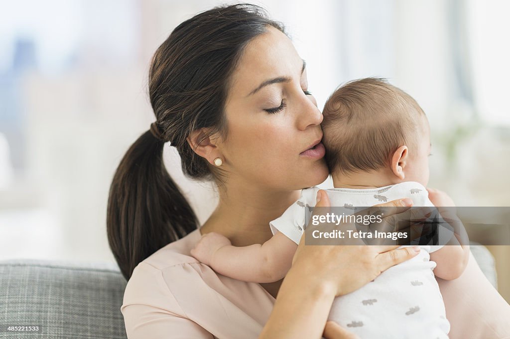 Mother embracing baby boy (2-5 months)