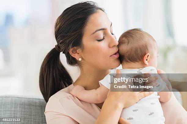 Mother Embracing Baby Boy High-Res Stock Photo