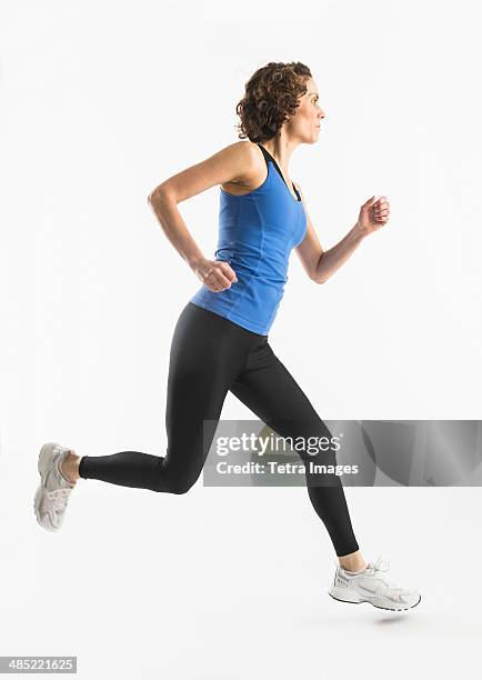 studio shot of mature woman jogging - one person in focus stock pictures, royalty-free photos & images