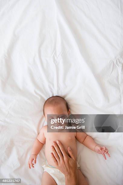 mother touching belly of baby girl (2-5 months) - baby girl laying on tummy stock pictures, royalty-free photos & images