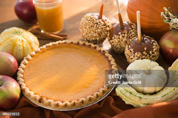 studio shot of homemade pumping pie and caramel apples - pumpkin pie stock pictures, royalty-free photos & images