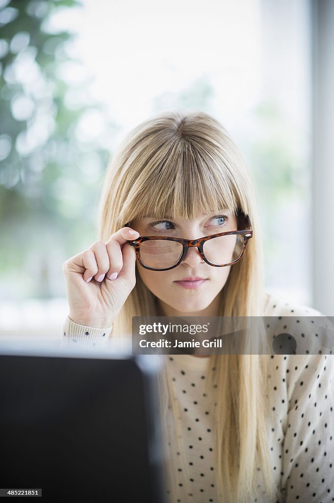 Woman looking above glasses