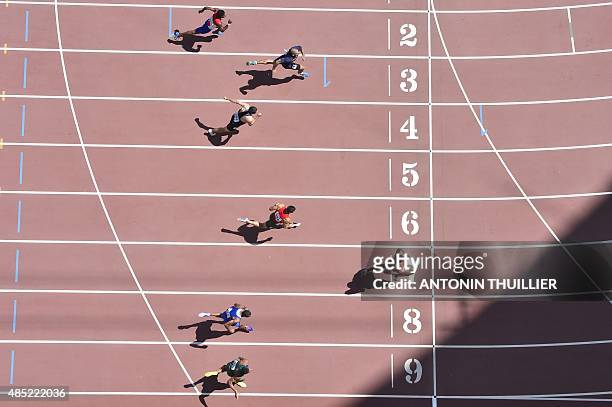 S David Oliver crosses the finish-line in a heat of the men's 110 metres hurdles athletics event at the 2015 IAAF World Championships at the "Bird's...