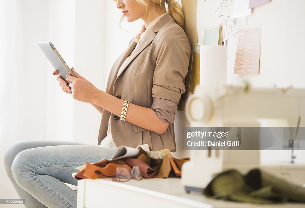 Teenage girl (16-17) using digital tablet, mid-section
