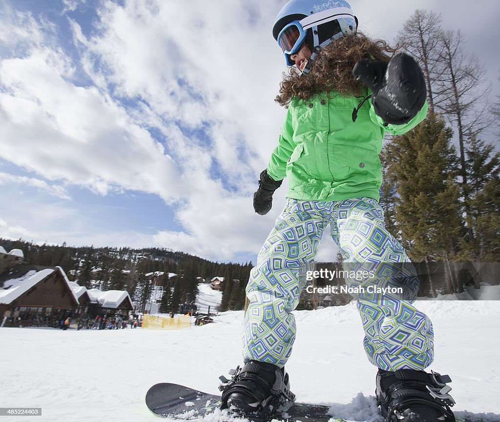 USA, Montana, Whitefish, Girl on snowboard