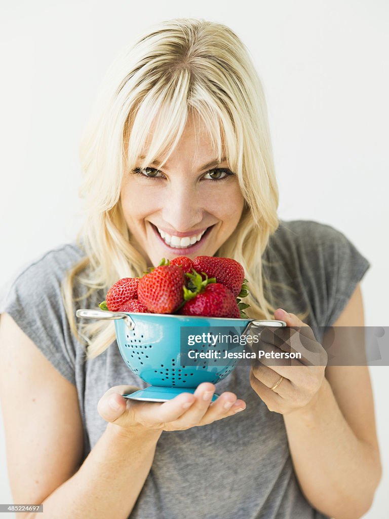 Woman holding fresh strawberries