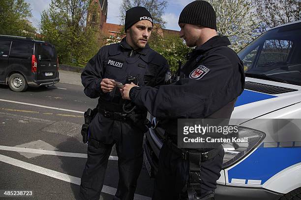 German policemen check the vehicle documents of a motorist near the Polish border on April 15, 2014 in Frankfurt an der Oder, Germany. May 1 will...
