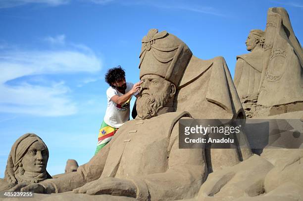 Sand sculptor carves his work, Suleiman the Magnificent, at Lara Beach on April 17, 2014 in Antalya, Turkey. 25 sculptors from 12 countries work on...