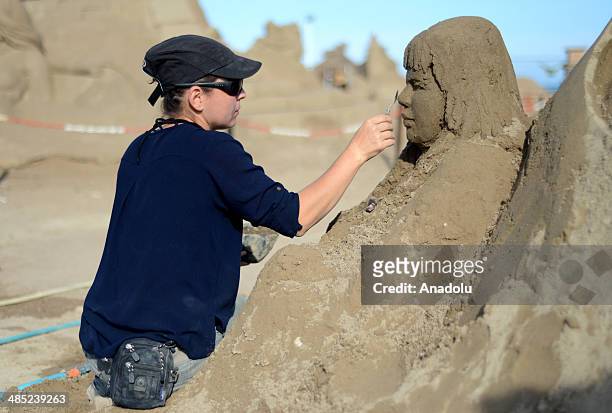 Sand sculptor carves her work at Lara Beach on April 17, 2014 in Antalya, Turkey. 25 sculptors from 12 countries work on the sculptures for the 8th...