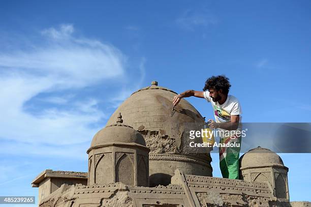 Sand sculptor carves his work at Lara Beach on April 17, 2014 in Antalya, Turkey. 25 sculptors from 12 countries work on the sculptures for the 8th...