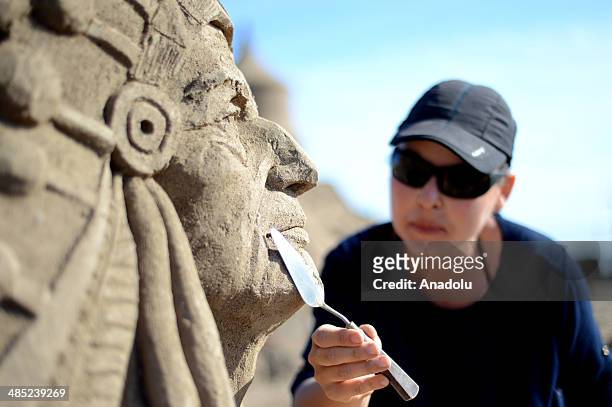 Sand sculptor carves her work, Geronimo, at Lara Beach on April 17, 2014 in Antalya, Turkey. 25 sculptors from 12 countries work on the sculptures...