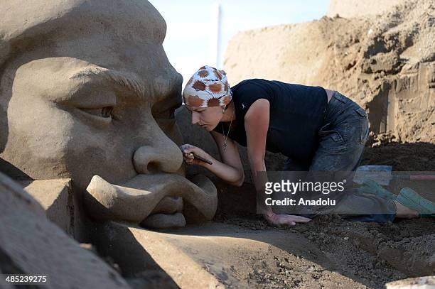 Sand sculptor carves her work, Huang Di , at Lara Beach on April 17, 2014 in Antalya, Turkey. 25 sculptors from 12 countries work on the sculptures...