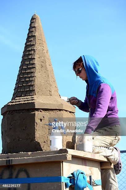Sand sculptor carves her work at Lara Beach on April 17, 2014 in Antalya, Turkey. 25 sculptors from 12 countries work on the sculptures for the 8th...