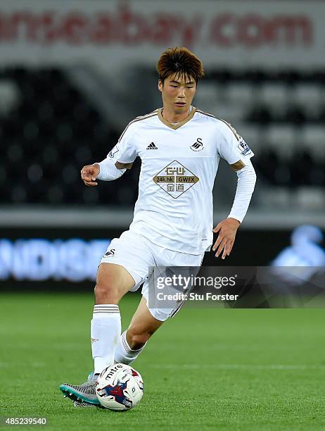 Swansea player Ki Sung Yueng in action during the Capital One Cup Second Round match between Swansea City and York City at Liberty Stadium on August...