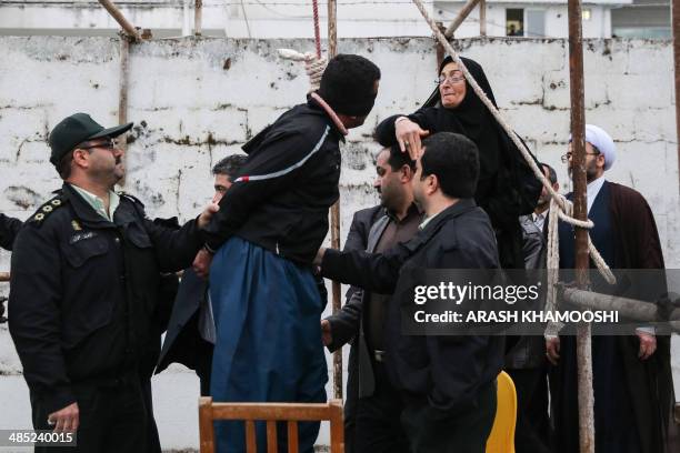 The mother of Abdolah Hosseinzadeh, who was murdered in 2007, slaps Balal who killed her son during the execution ceremony in the northern city of...