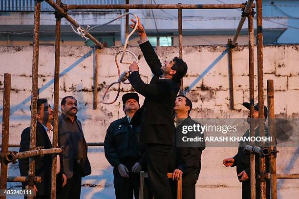 Iranian officials prepare the noose for the execution of Balal, who killed fellow Iranian youth Abdolah Hosseinzadeh in a street fight with a knife...