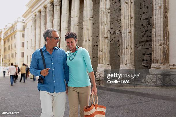 couple walking in piazza di pietra, italy - rome tourist stock pictures, royalty-free photos & images