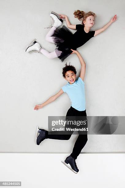 figure skating boy and girl - figure skating child stock pictures, royalty-free photos & images