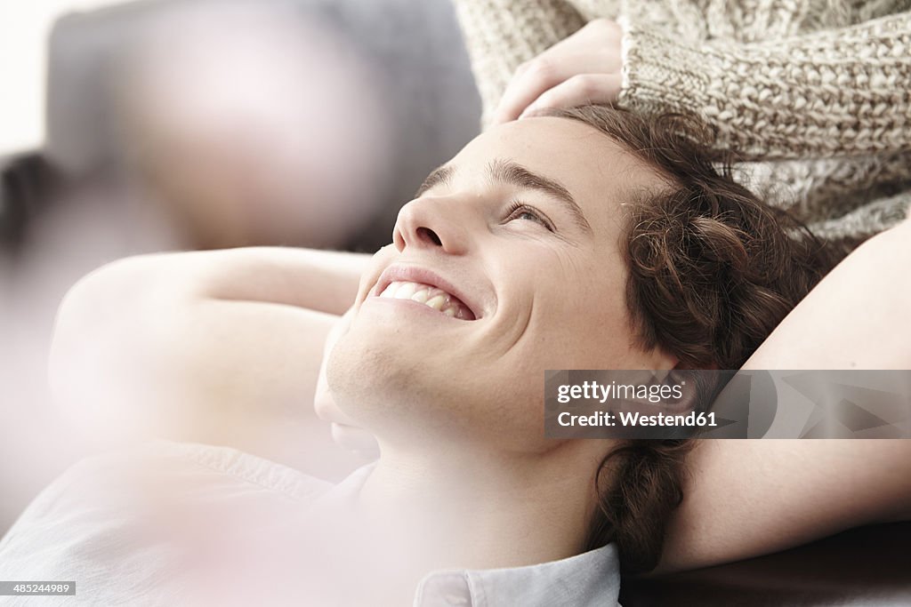 Portrait of happy young man stroked by his girlfriend