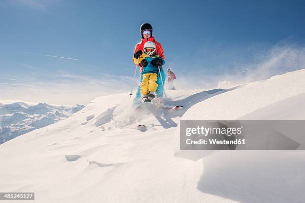 austria, salzburg country, altenmarkt-zauchensee, family skiing in mountains - family winter sport stock pictures, royalty-free photos & images