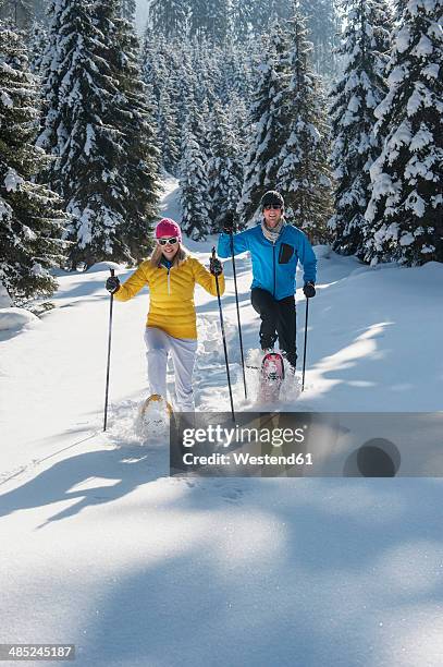 austria, salzburg state, altenmarkt-zauchensee, couple snowshoeing in winter landscape - schneeschuhwandern stock-fotos und bilder