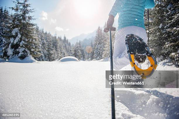 austria, salzburg state, altenmarkt-zauchensee, woman snowshoeing in winter landscape - snowshoe stock pictures, royalty-free photos & images
