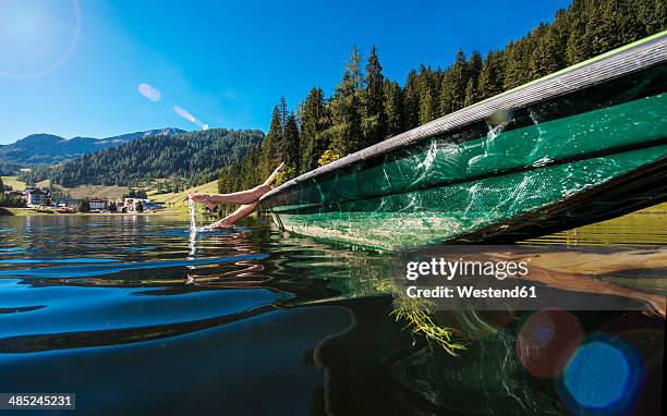 austria, salzburg state, altenmarkt-zauchensee, woman lying in a boat - lagos state fotografías e imágenes de stock