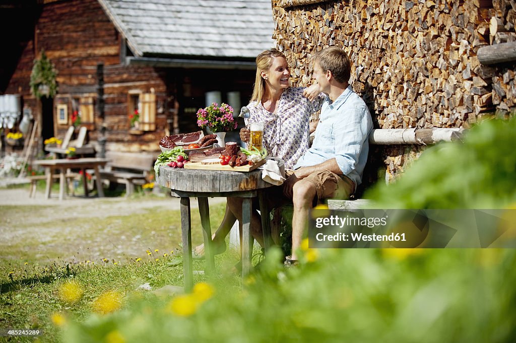 Austria, Salzburg State, Altenmarkt-Zauchensee, couple having an alpine picnic