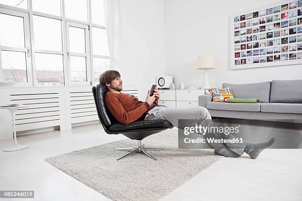 germany, munich, man reading e-book - convenience stock pictures, royalty-free photos & images