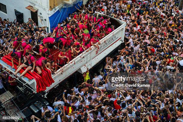 Revellers enjoy the atmosphere in tomato pulp while participating the annual Tomatina festival on August 26, 2015 in Bunol, Spain. An estimated...