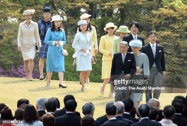 Emperor AKihito, Empress Michiko and royal family members walk toward the guest during the spring garden party at Akasaka Palace on April 17, 2014 in...