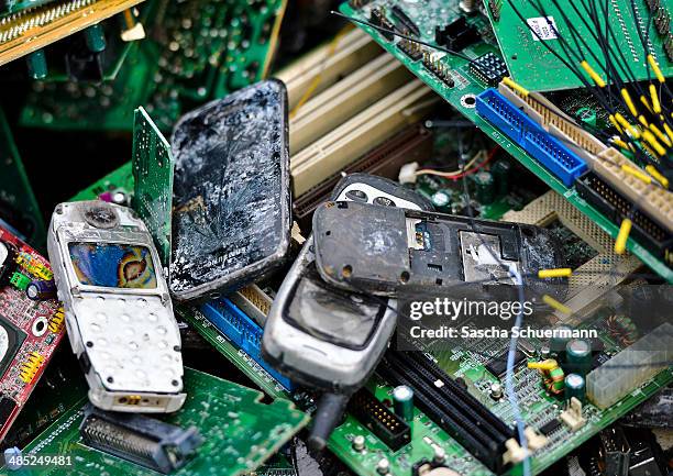 Old mobile phones lie between lectronic components including circuit boards sit in a pile ahead of recycling at the Aurubis AG metal refinery on...