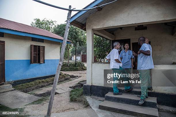 Doctors from different countries chat outside Lassa isolation ward at Gondama Referral Centre on March 4, 2014 in Bo district, Sierra Leone. In some...