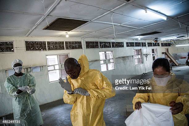 Healthcare workers wear protective equipment as they work at Lassa isolation ward at Gondama Referral Centre on March 3, 2014 in Bo district, Sierra...