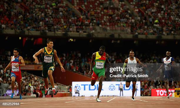 Wayde Van Niekerk of South Africa crosses the finish line to win gold ahead of Kirani James of Grenada in the Men's 400 metres final during day five...