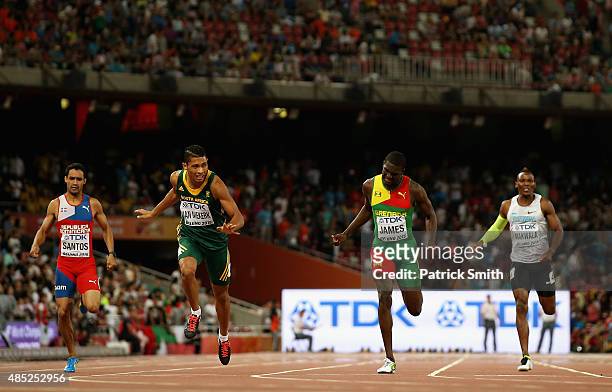 Wayde Van Niekerk of South Africa crosses the finish line to win gold ahead of Kirani James of Grenada in the Men's 400 metres final during day five...