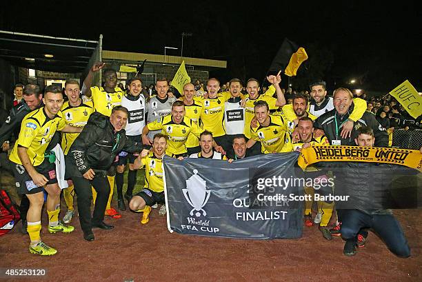 Heidelberg United players celebrate with their qualification flag after winning the FFA Cup Round of 16 match between Heidelberg United and Sydney...