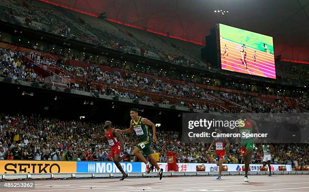 Wayde Van Niekerk of South Africa crosses the finish line to win gold ahead of Lashawn Merritt of the United States and Kirani James of Grenada in...