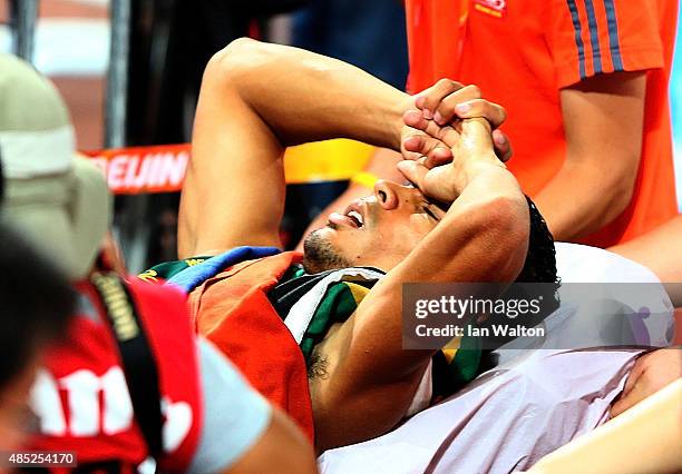 Wayde Van Niekerk of South Africa is stretchered off after winning gold in the Men's 400 metres final during day five of the 15th IAAF World...