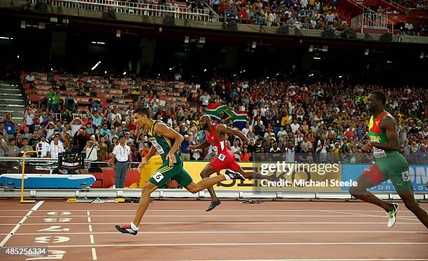 Wayde Van Niekerk of South Africa crosses the finish line to win gold ahead of Lashawn Merritt of the United States and Kirani James of Grenada in...