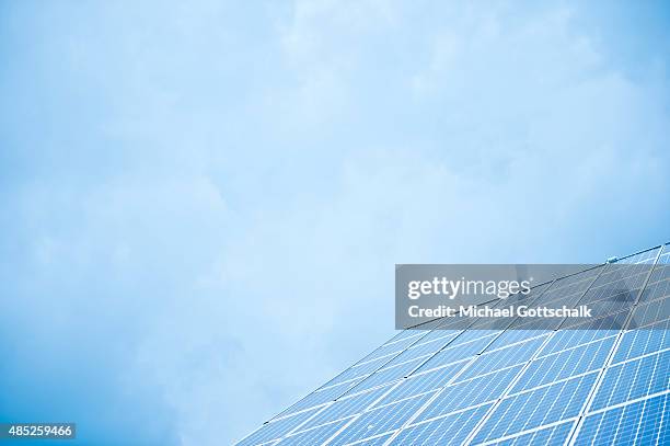 Berlin, Germany Solar panels on a roof of a house with blue sky in the background on August 25, 2015 in Berlin, Germany.