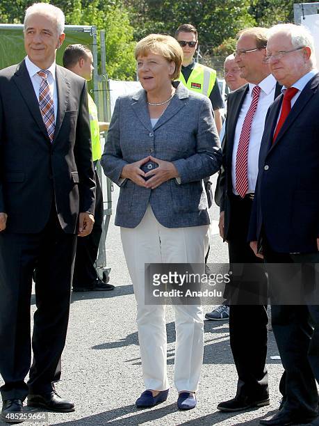 German Chancellor Angela Merkel , Saxony Governor Stanislaw Tillich and German Red Cross president Rudolf Seiters visit an asylum shelter in...