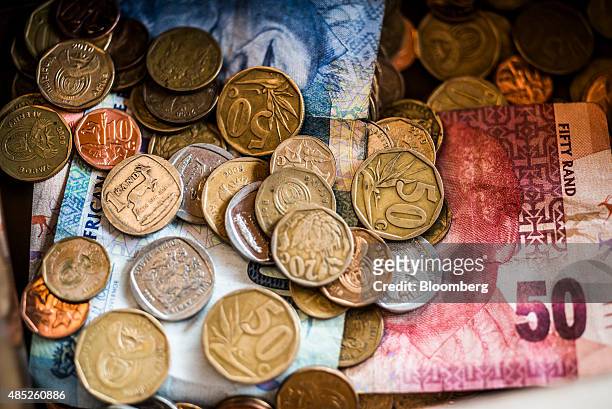 Rand coins and banknotes sit in a cash box in Johannesburg, South Africa, on Wednesday, Aug. 26, 2015. More than four years of currency declines --...